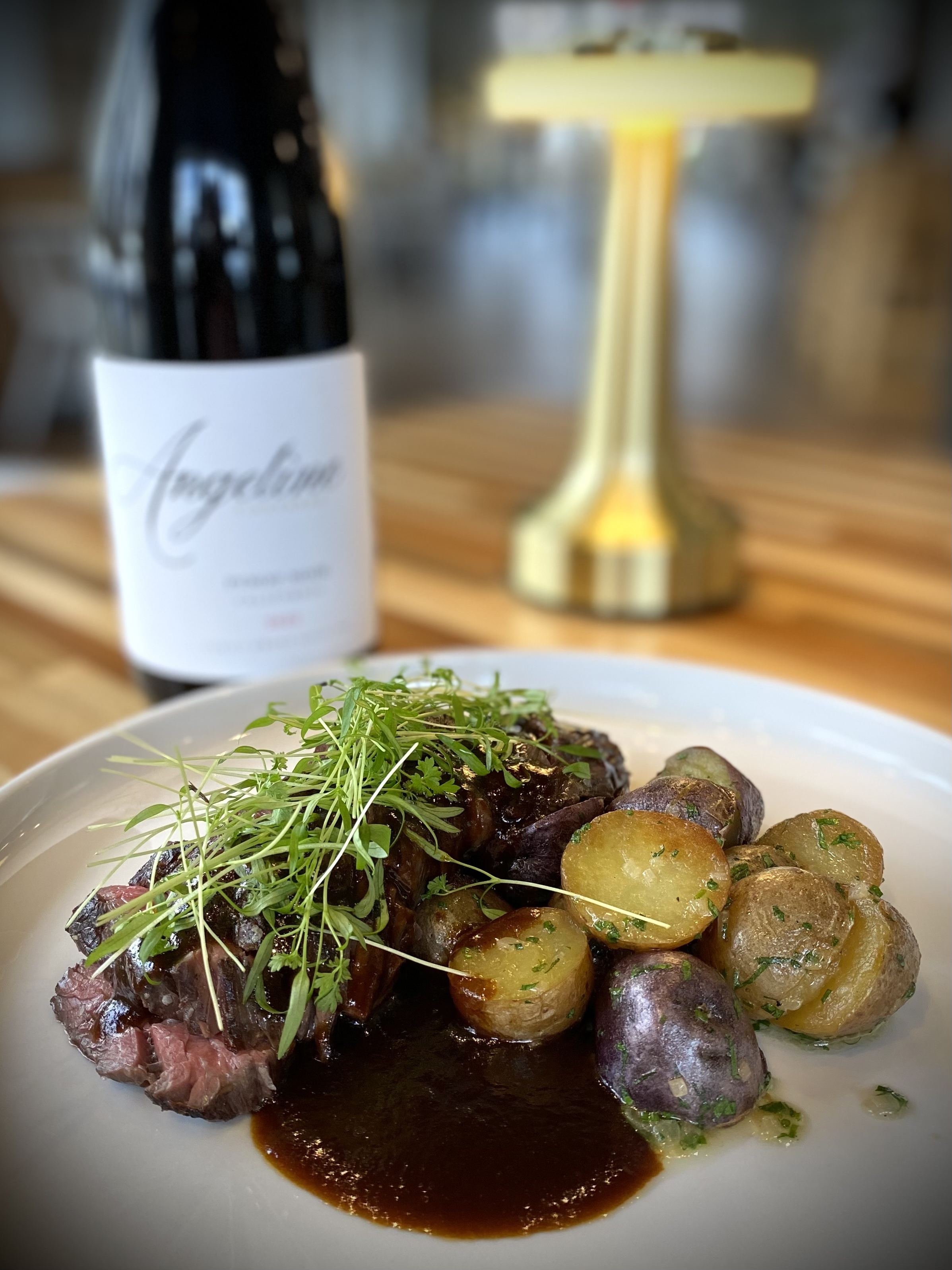 Hanger Steak with savory demi-glacé, paired with fingerling potatoes.
