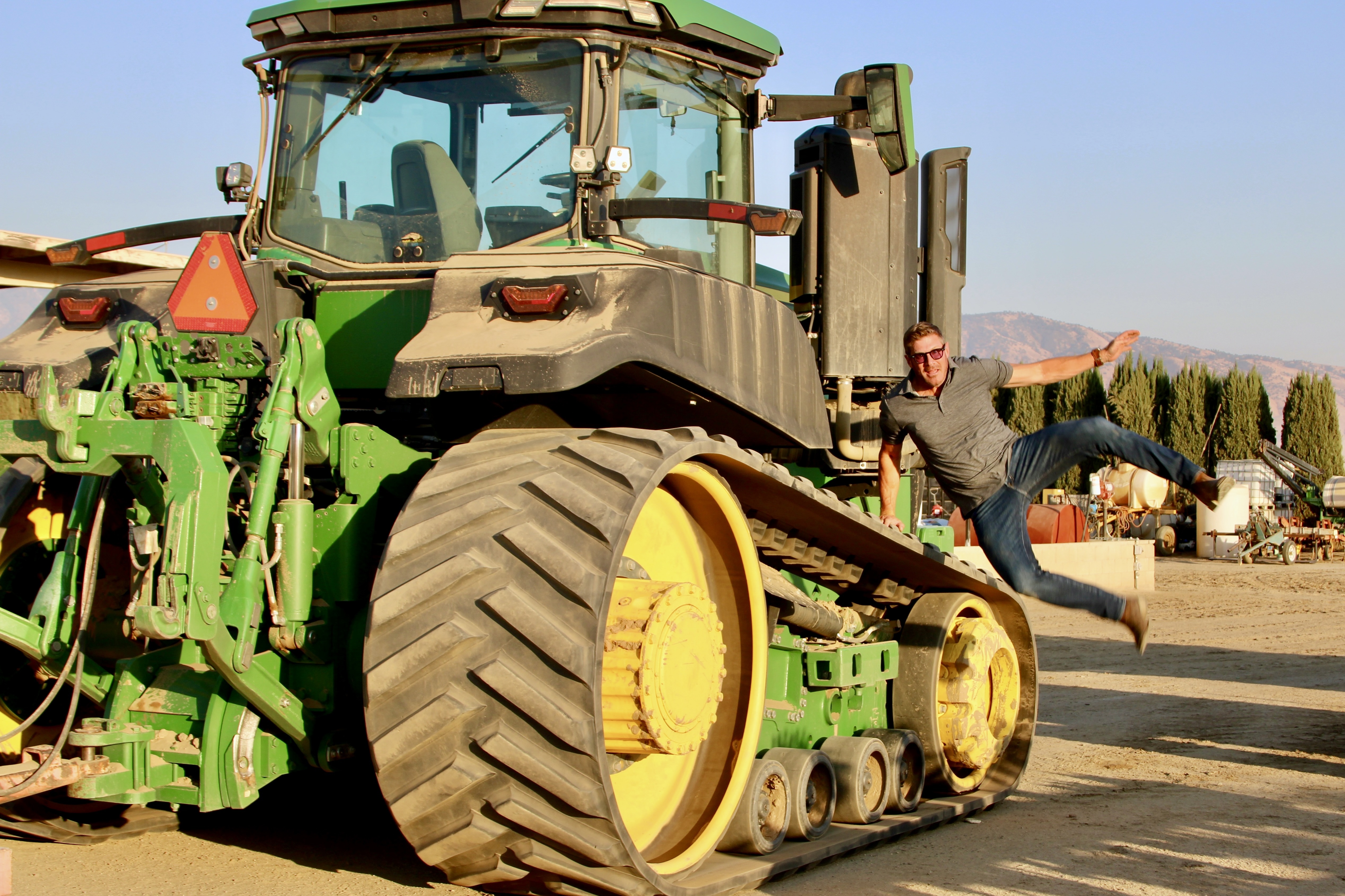 Jason jumping off his tractor, courtesy of Casey Dee