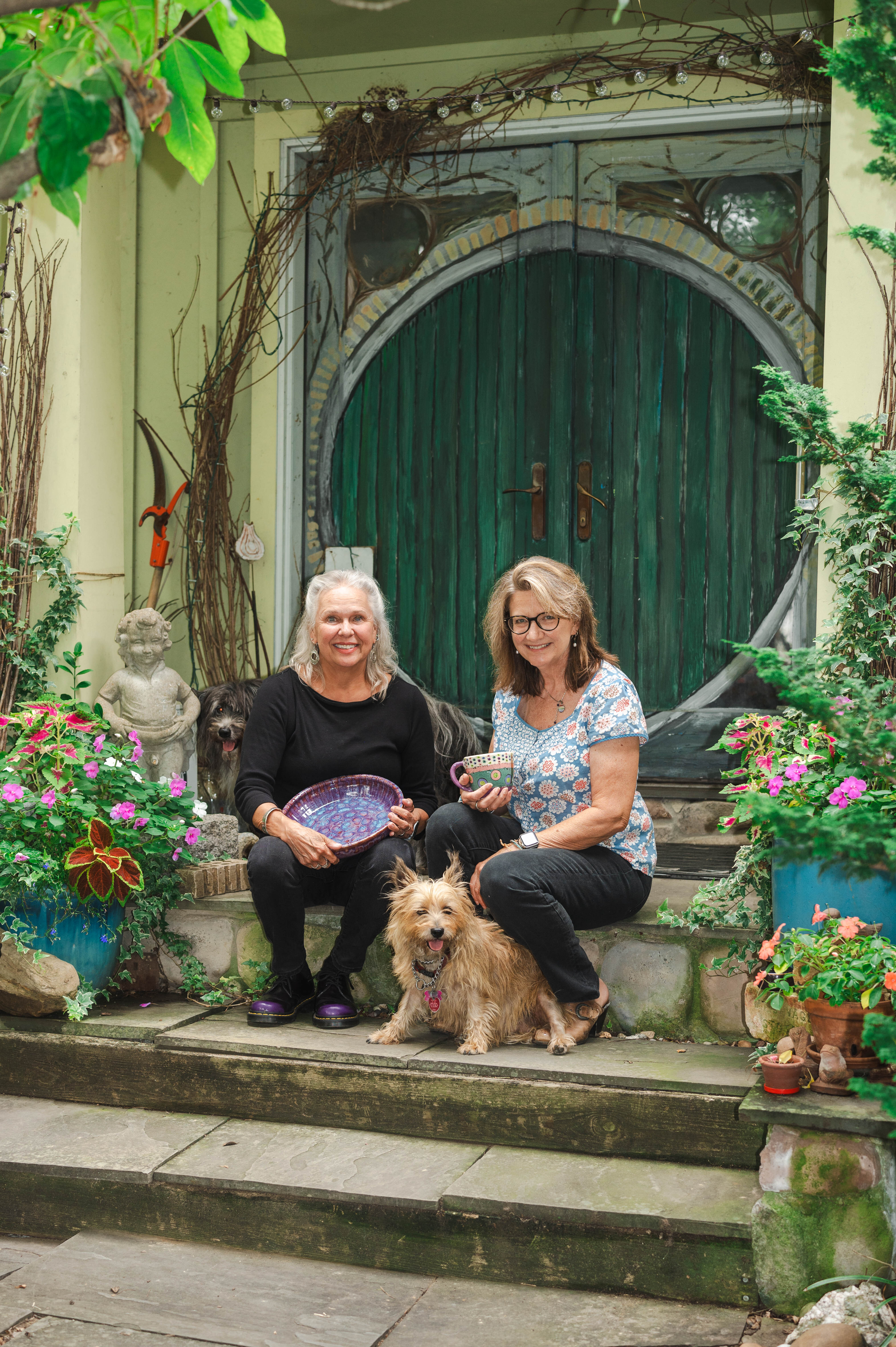Art on the Avenue favorites Lisa Schumaier and Beth Coast in front of Schumaier's Del Ray home studio.  Both Schumaier and Coast have participated in Art on the Avenue for over 20 years.  PHOTO BY OLIVIA GRAVATT