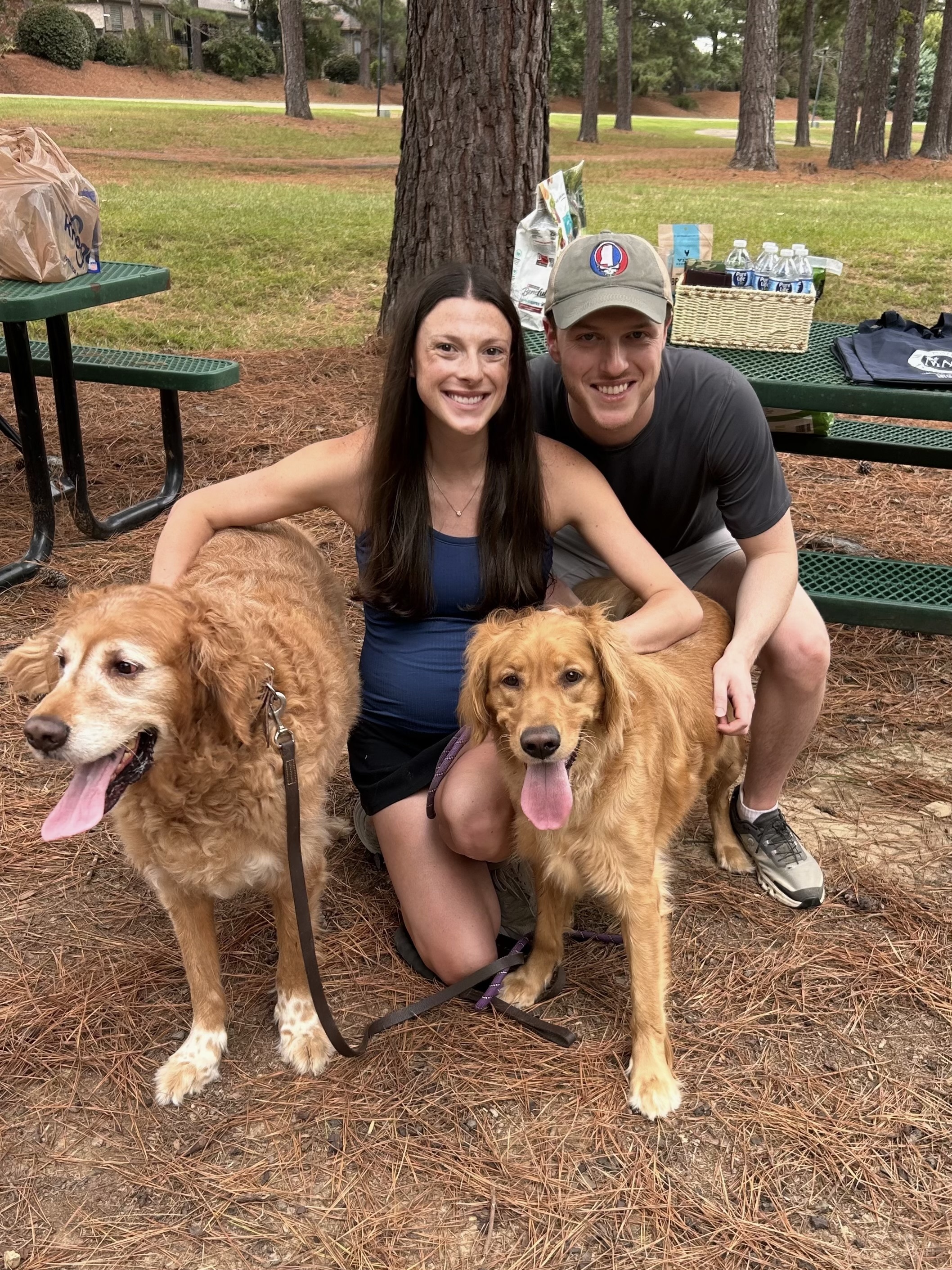Hosts Devan and Alex Bucklew with their two goldens, Molly and Maverick.