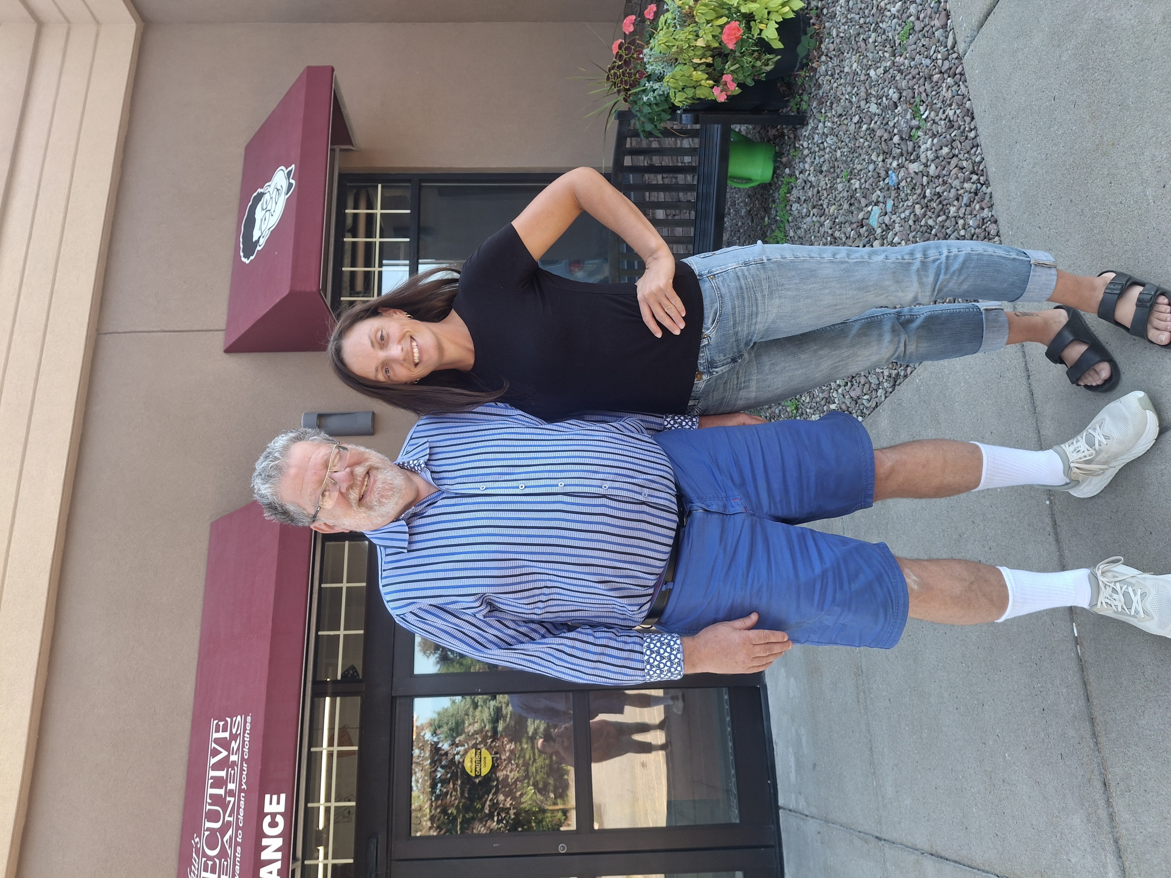 Arthur and Madeline pose in front of the store