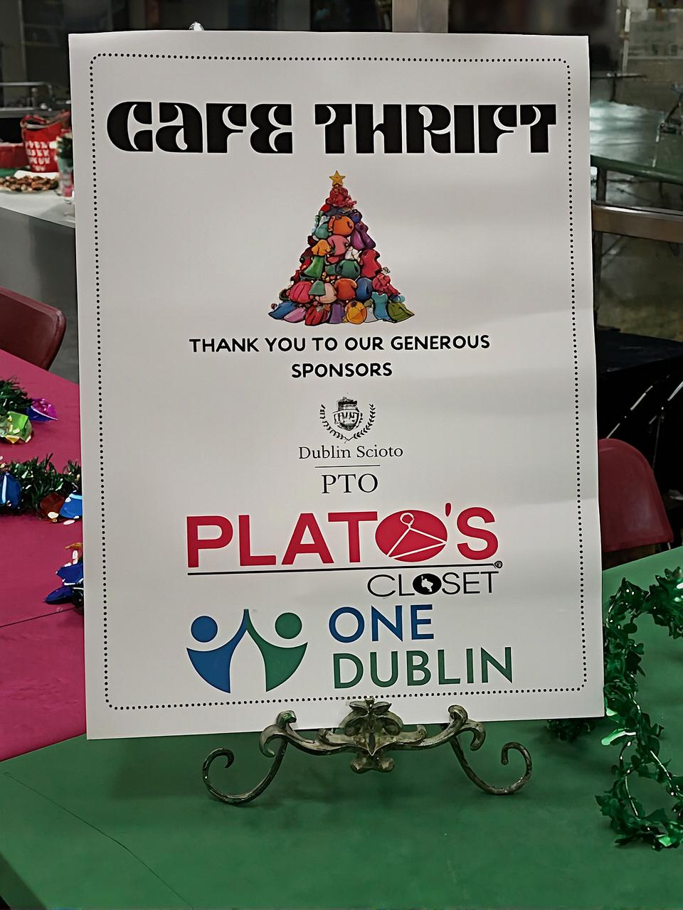 A festive Café Thrift sign thanks generous sponsors, including Plato’s Closet, One Dublin, and the Dublin Scioto PTO, for making the event possible.