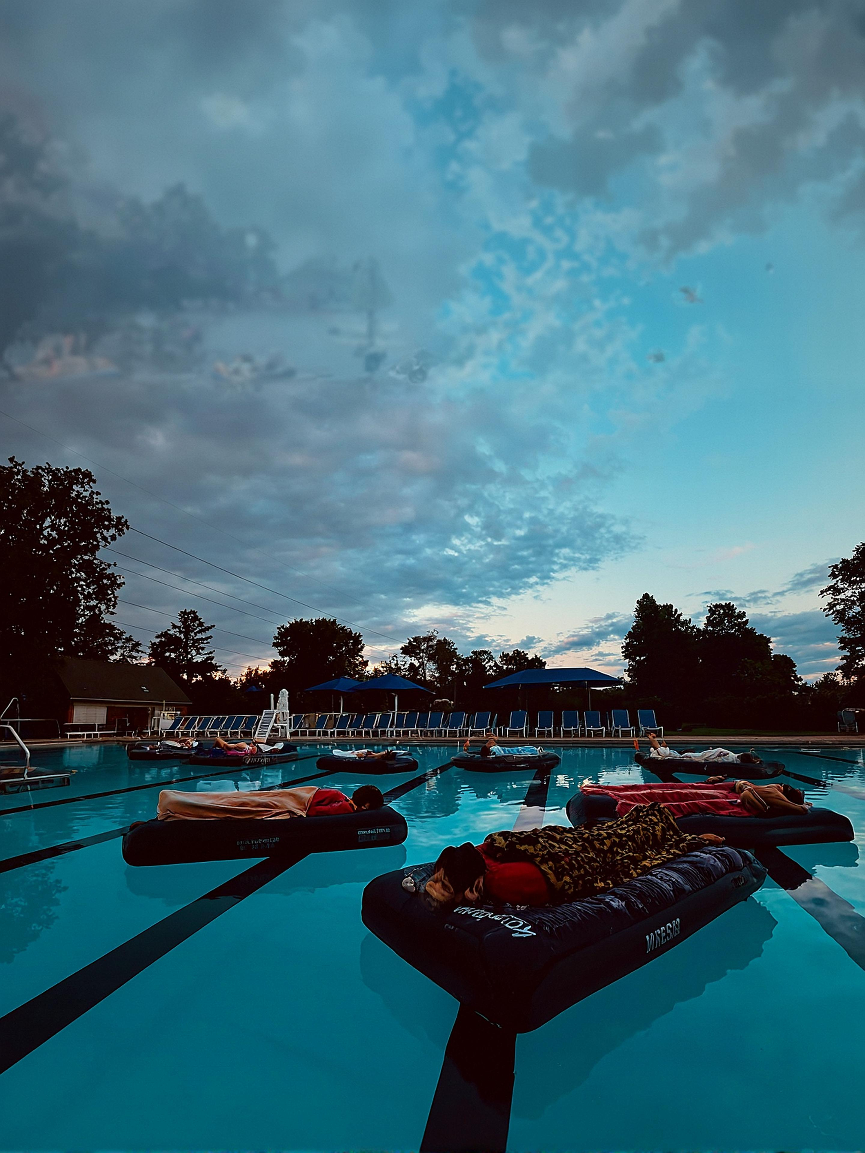 Members drift peacefully on floating mats during the Club at Tartan Fields’ first-ever Floating Sound Bath—an evening of relaxation, sound therapy, and serenity under the open sky.