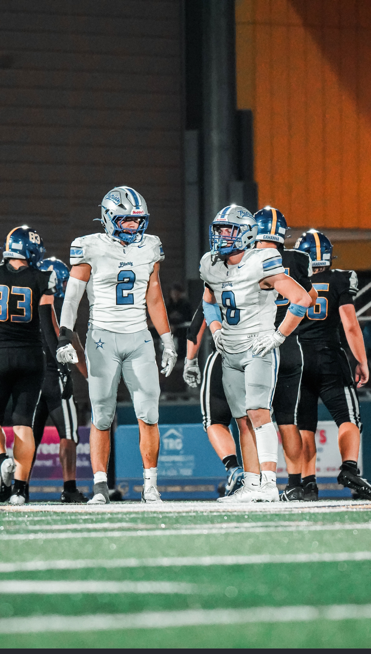 Hudson Dorsey (#2) and teammate regroup during a tough matchup under the Friday night lights.
