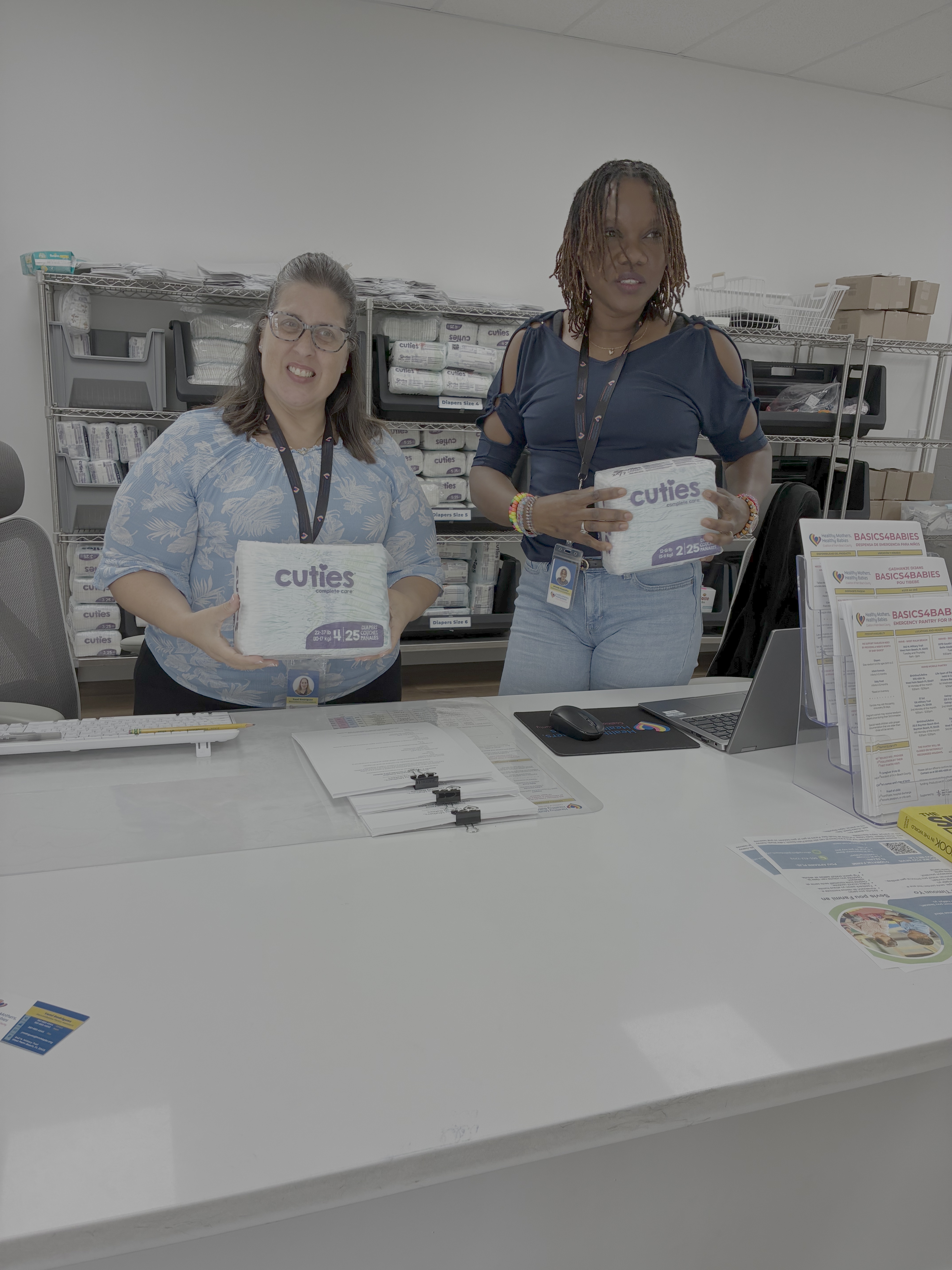 Yami Rodriguez & Islande Hyppolite distributing diapers in the pantry