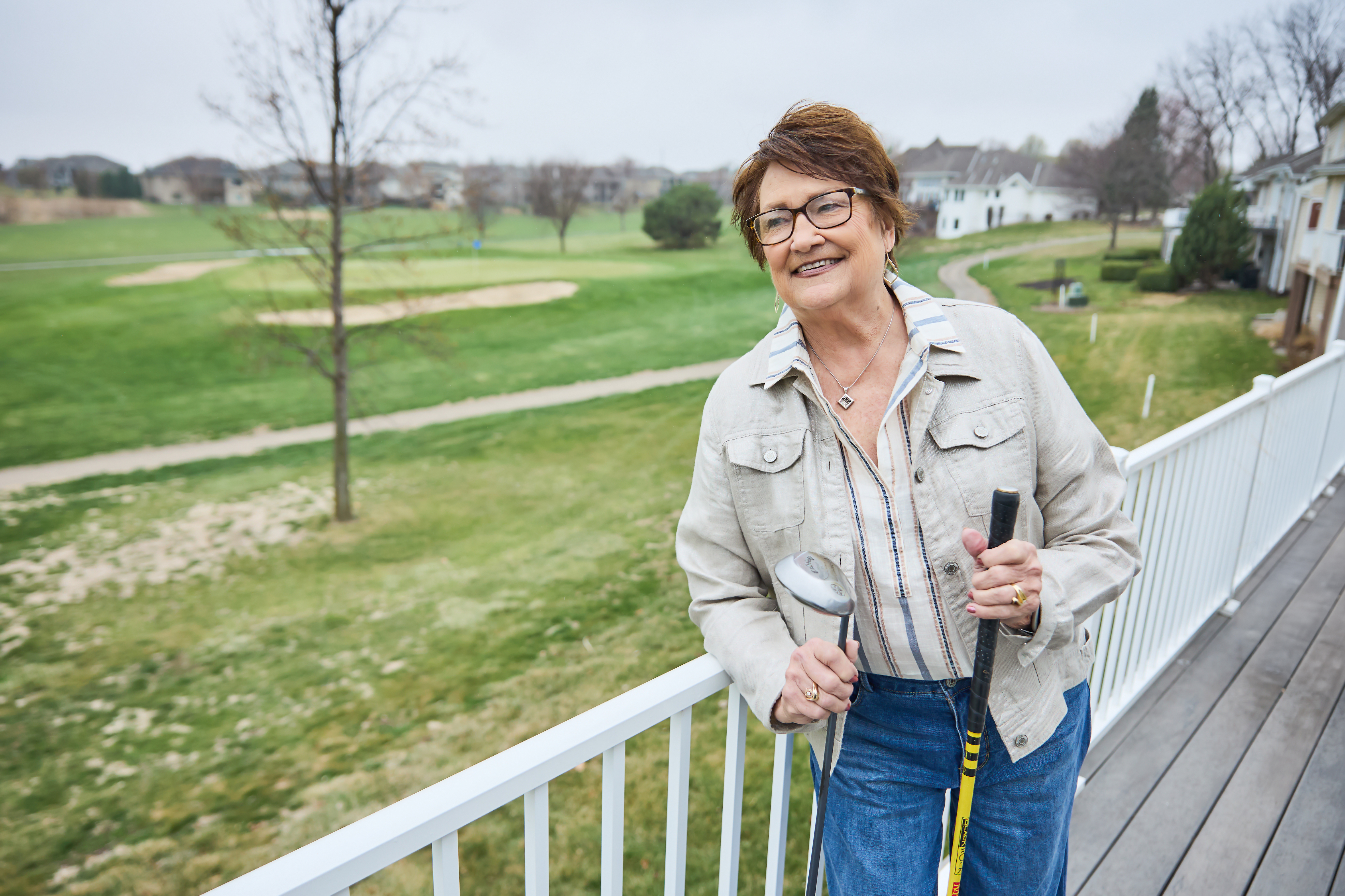 Kathy Allen on her back deck overlooking the tree planted in her husband Ken's memory.