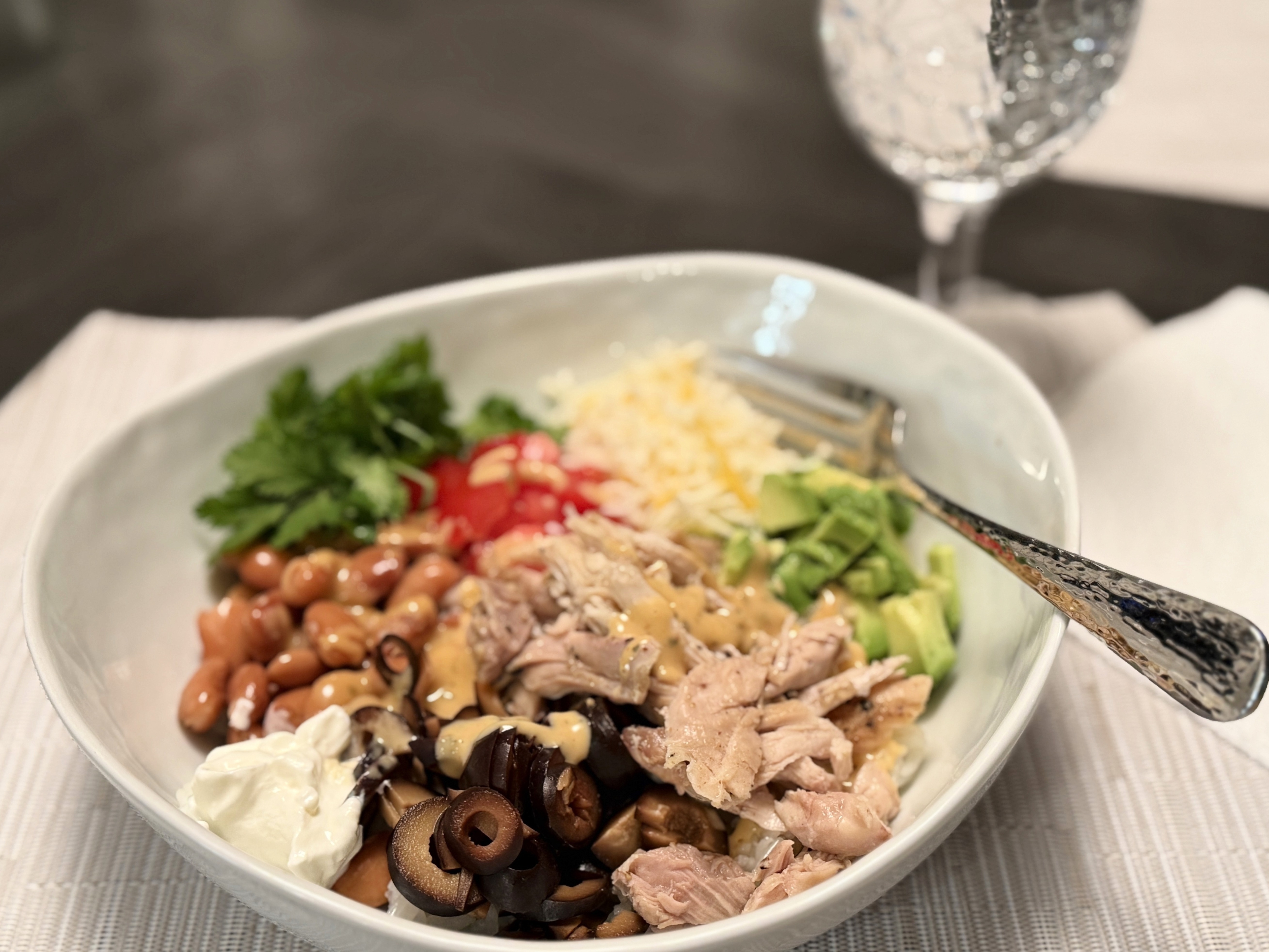 Yumm Bowl loaded with rice, beans, chicken, fresh toppings, and a generous drizzle of signature Yumm Sauce.