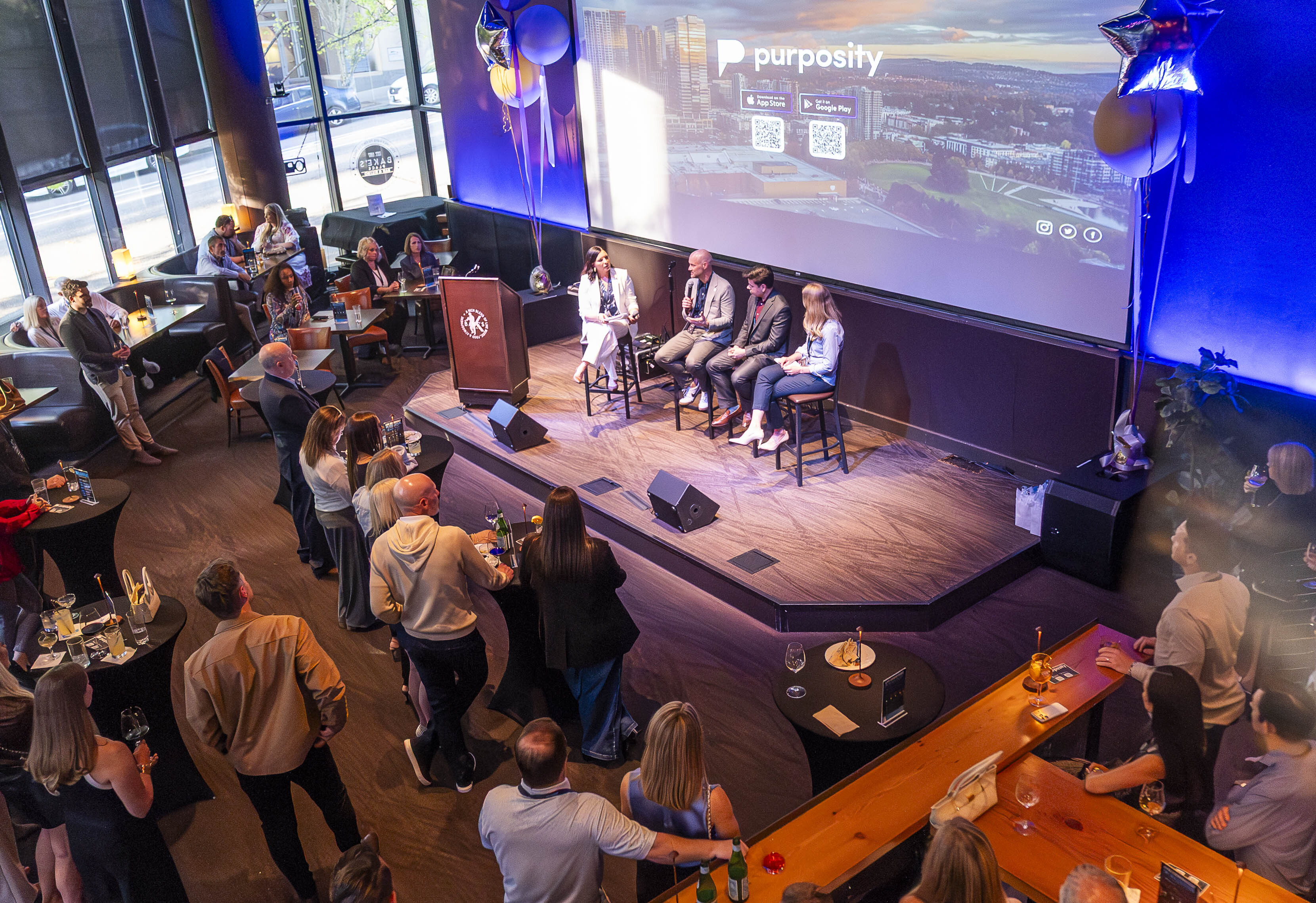 Emcee Jen Mueller interviewing panelists Aaron Monts from Eastside Academy, Dr. Ricardo Macias Tamez from Bellevue School District and Kris Howard from Bellevue Lifespring