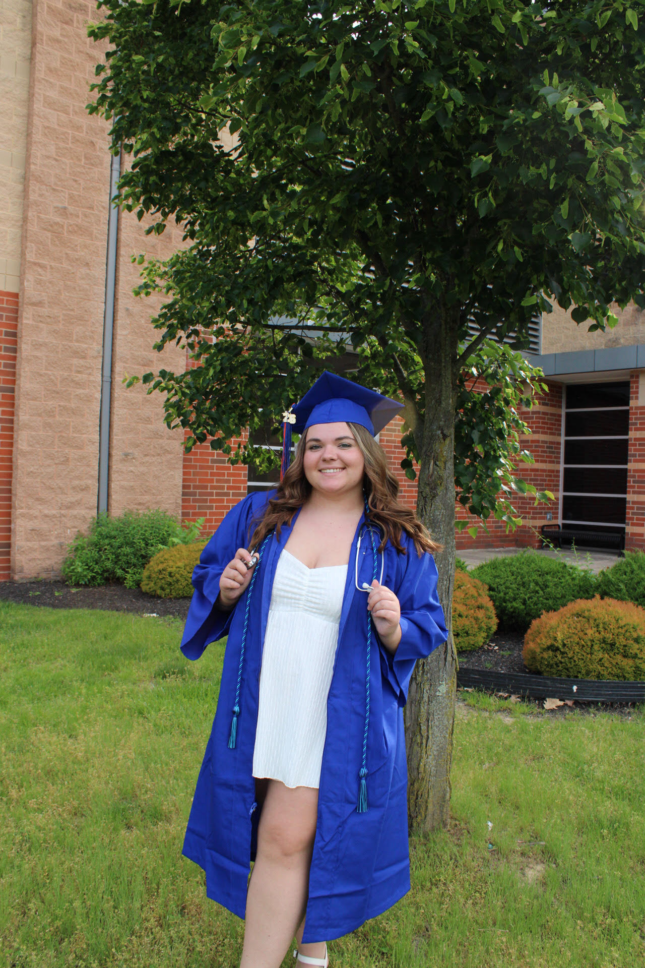 Megan wears a smile while posing in her cap and gown.