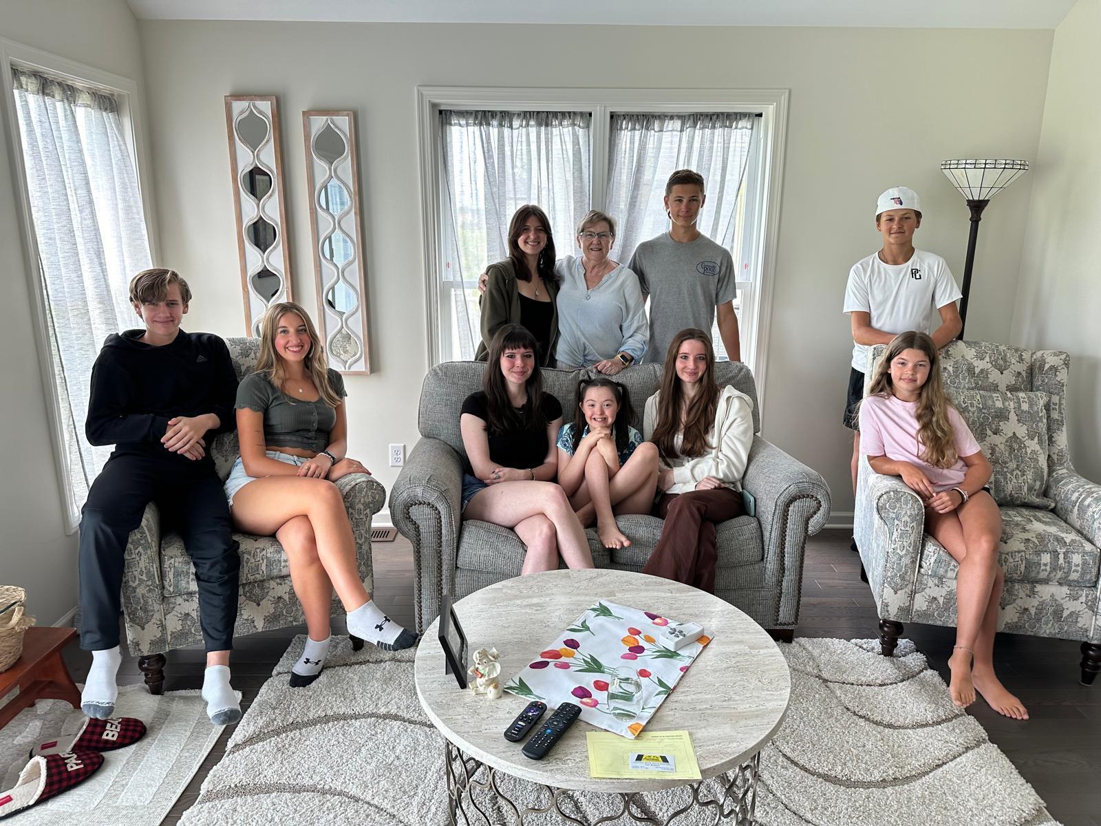 Alice surrounded by her greatest blessing: all nine of her grandchildren.