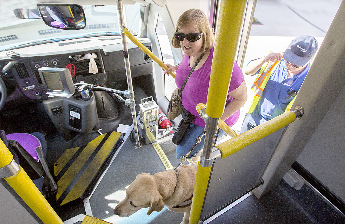 Transportation Assistance Program participant and her service dog heading out to do some shopping.