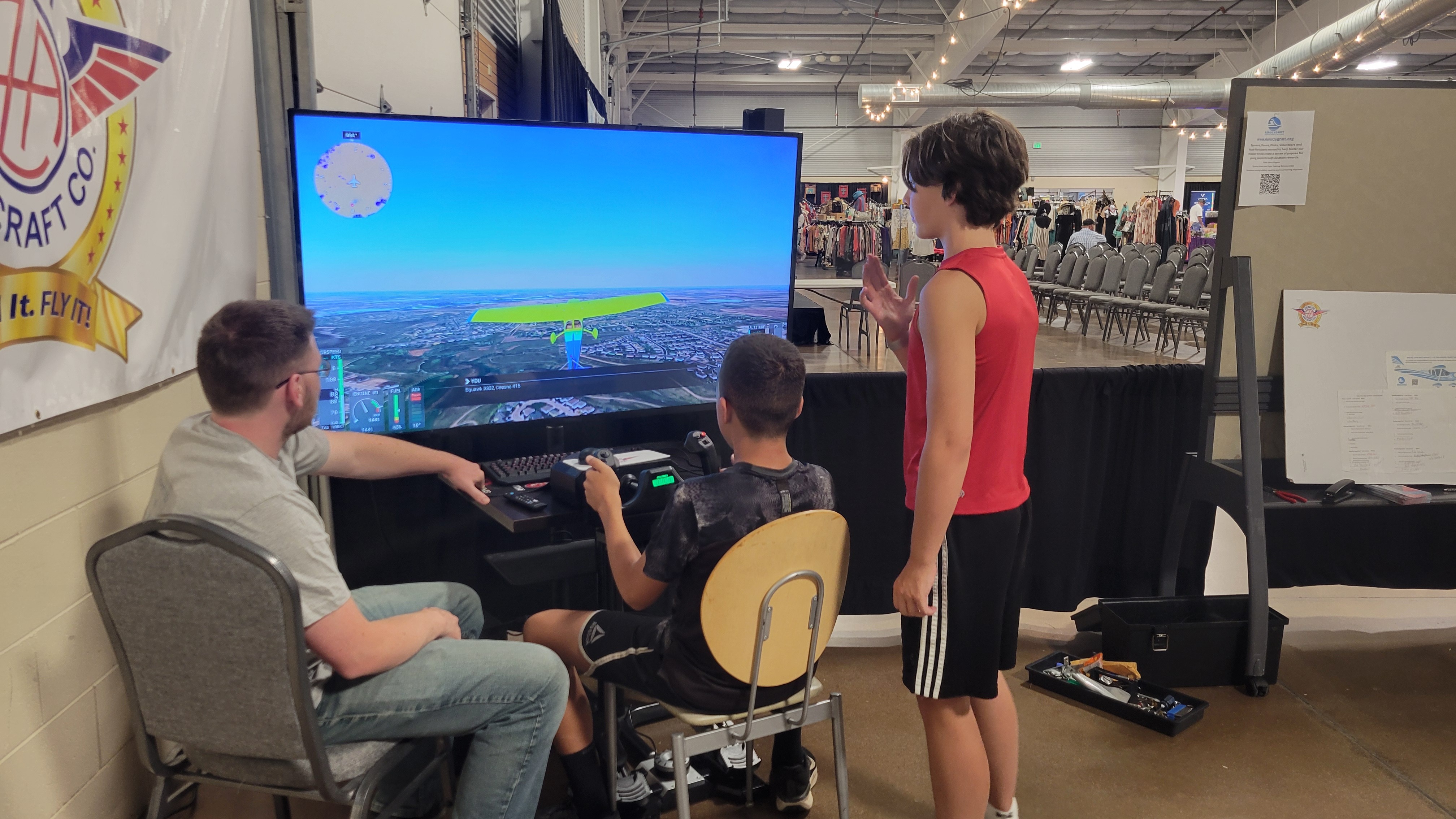 Students are instructed on how to fly a Cessna 172 in the Aero Cygnet Flight Simulator by Highland Meadow resident Tyler Dehn