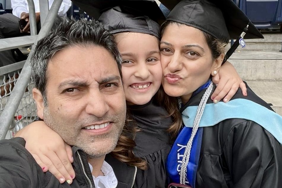 On my graduation day, I was surrounded by my biggest cheerleaders, my husband and my daughter.