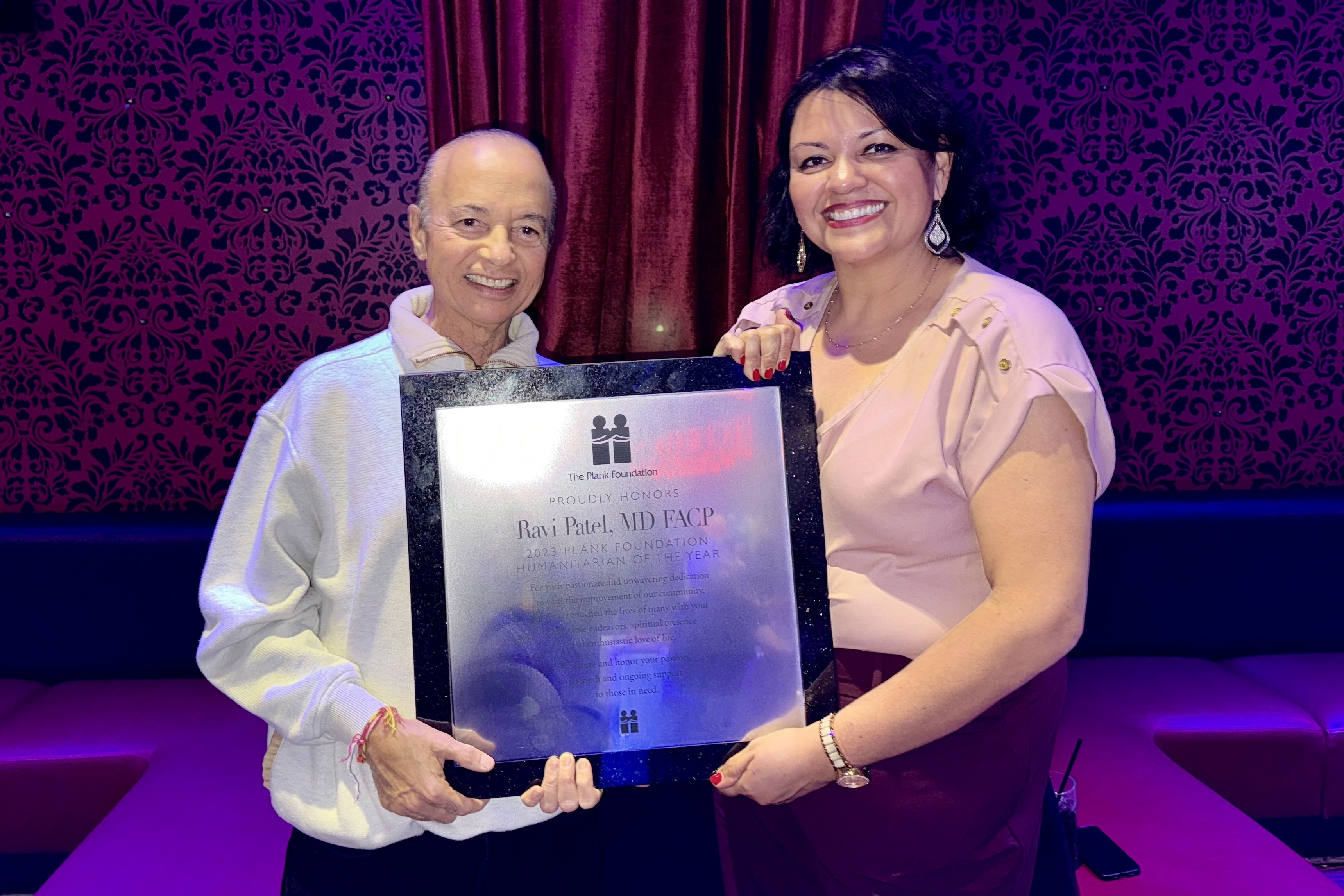 Dr Patel receiving the Plank Foundation Award with Michelle Avila