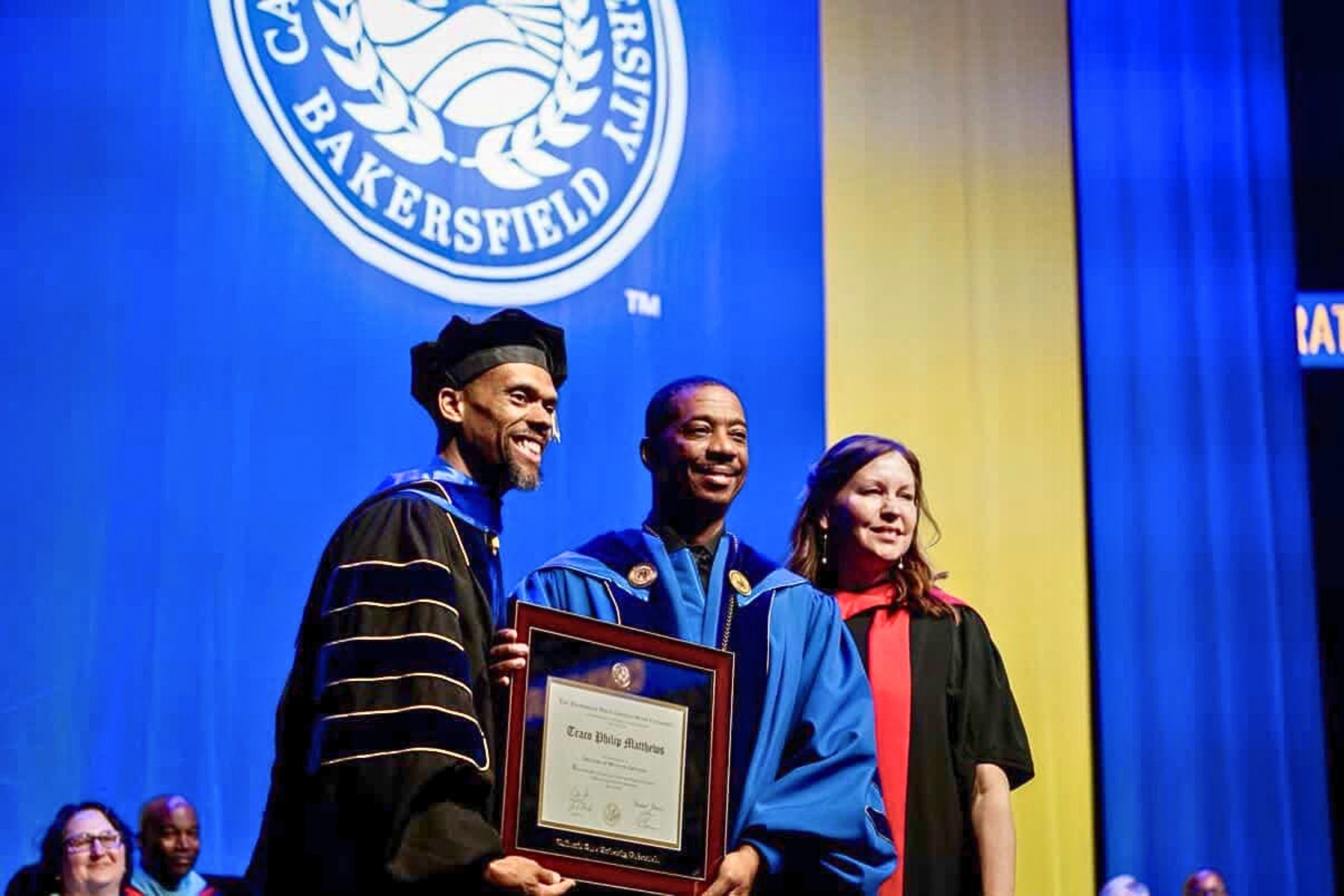 Traco, receiving his doctorate from CSUB President Dr. Vernon B. Harper Jr., with Bakersfield Provost and Vice President for Academic Affairs Dr. Deborah Thien