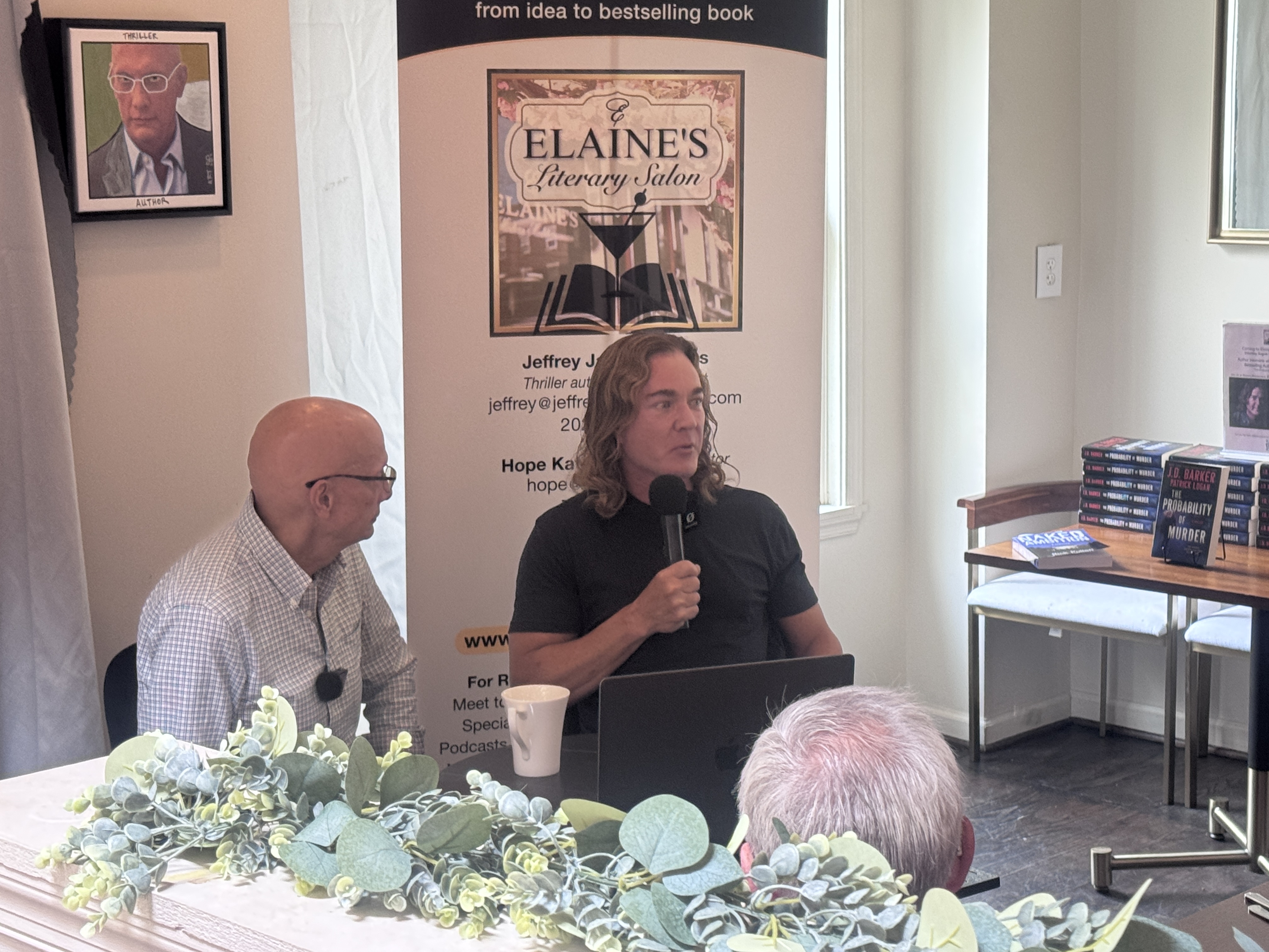 Jeffrey Higgins, left, hosting a literary salon in August. Photo by Brett Kitchen.