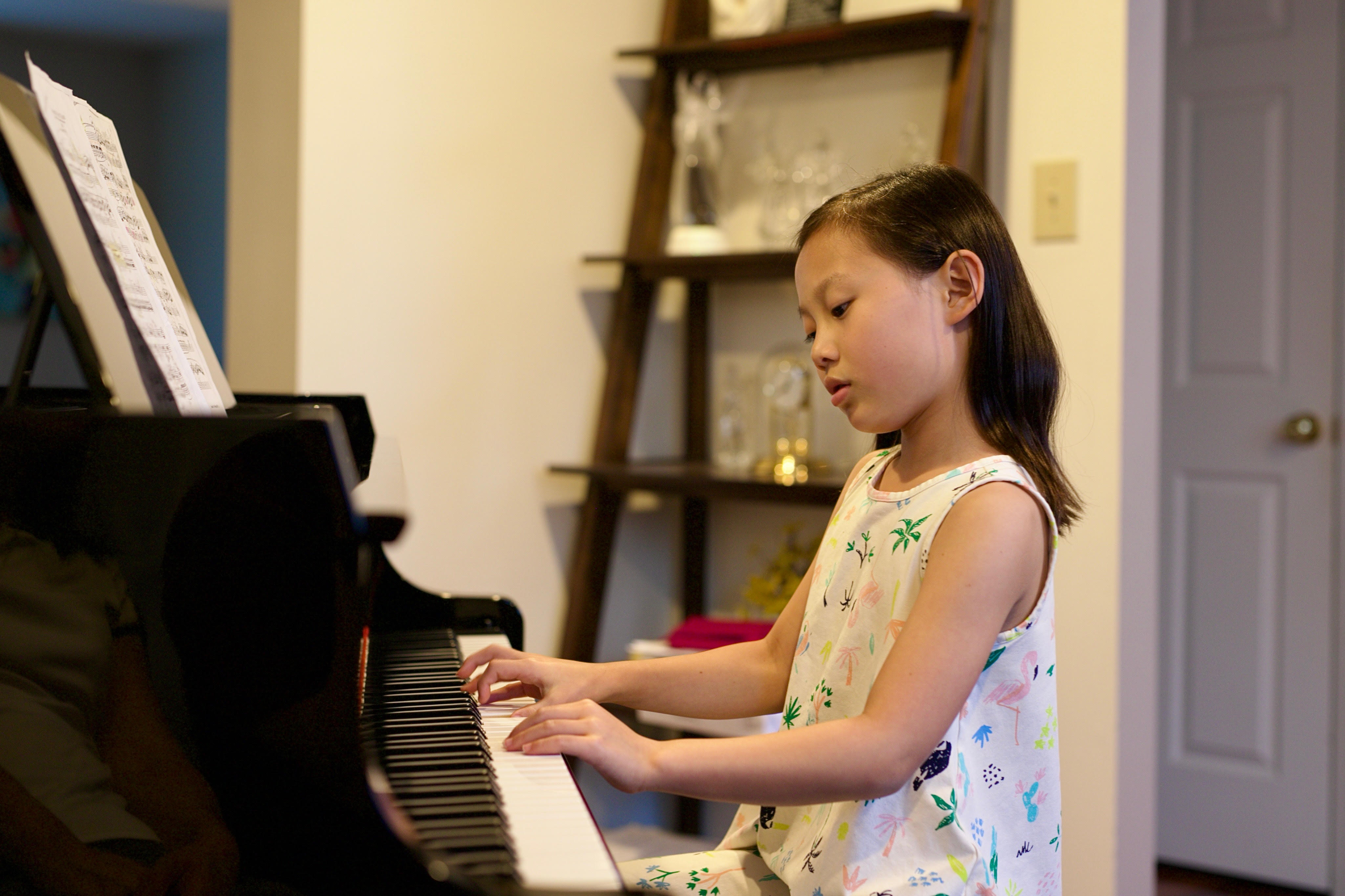 Alyssa playing the piano at home.